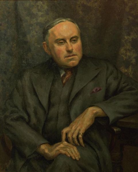 Painting. Shown from the lap up, a pale-skinned, clean-shaven man sits looking off to our right with deep-set, small eyes. His head tips to our left. His grey hair is combed over his head, and he has chubby cheeks and a cleft in his chin. He wears a three-piece grey suit, and is shown in front of a grey curtain.